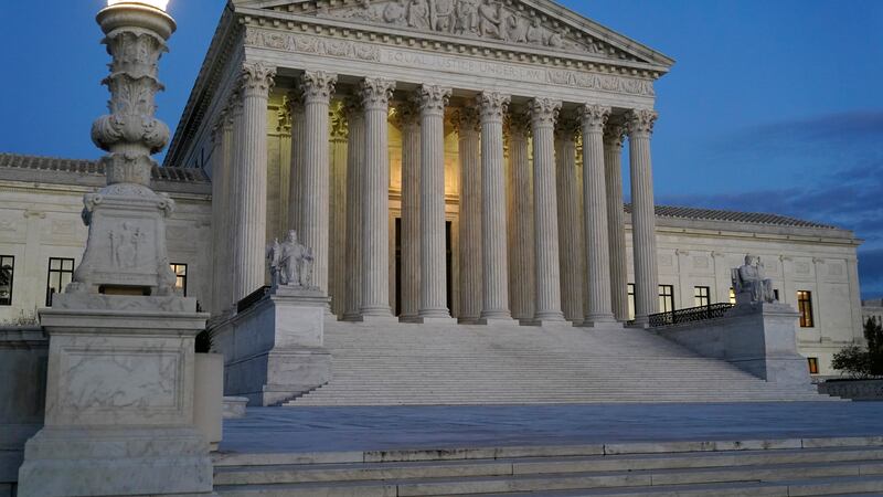 Light illuminates part of the Supreme Court building at dusk on Capitol Hill in Washington,...