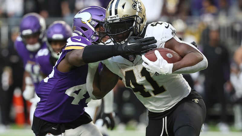 New Orleans Saints running back Alvin Kamara (41) is tackled by Minnesota Vikings safety Josh...