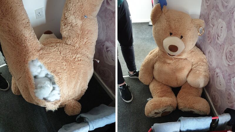 Photos shared by police show the teddy bear in which the suspect hid. It appears to be about 5...