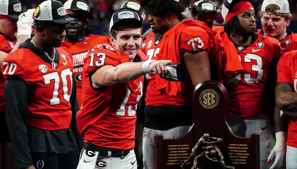 Georgia quarterback Stetson Bennett (13) gestures to the crowd during the trophy presentation...